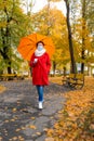 Senior woman protective medical mask autumn park age middle 50 plus umbrella red orange Royalty Free Stock Photo