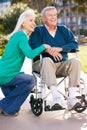 Senior Woman Pushing Husband In Wheelchair Royalty Free Stock Photo