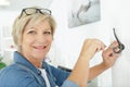 senior woman putting hook on wall Royalty Free Stock Photo