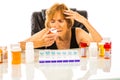 Senior Woman Questioning Pill Container As Part Of Her Weekly Pill Box