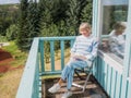 Senior woman is reading at a balcony Royalty Free Stock Photo