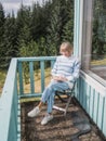 Senior woman is reading at a balcony Royalty Free Stock Photo