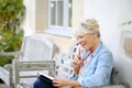 Senior woman reading book enjoying Royalty Free Stock Photo