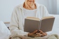 Senio reading book in nursing home