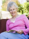 Senior woman reading book outside Royalty Free Stock Photo