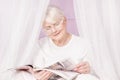 Senior woman reading magazine. Royalty Free Stock Photo