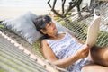 Senior woman reading a magazine in a hammock Royalty Free Stock Photo