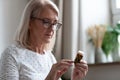 Senior woman reading medicines instruction on pills bottle