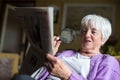 Senior woman reading morning newspaper