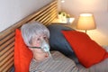 Senior woman receiving breathing treatment