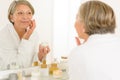 Senior woman reflection in bathroom mirror Royalty Free Stock Photo