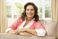 Senior Woman Relaxing In Chair At Home Royalty Free Stock Photo