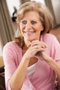 Senior Woman Relaxing In Chair At Home Royalty Free Stock Photo