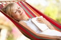 Senior Woman Relaxing In Hammock Royalty Free Stock Photo