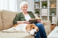 Senior Woman Relaxing at Home with Loved Pet