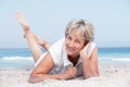 Senior Woman Relaxing On Sandy Beach Royalty Free Stock Photo