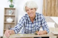 senior woman repairing furniture at home