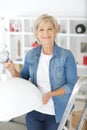Senior woman replacing light bulb at home