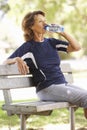 Senior Woman Resting After Exercise In Park Royalty Free Stock Photo