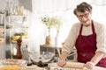 Senior woman rolling pizza dough