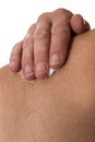 Senior woman rubbing her shoulder with a white pain relieving cr