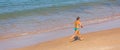 A senior woman running alone on a beach.