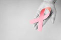 The senior woman hand in black and white supports Breast Cancer Day by holding Pink Ribbon Breast Cancer Awareness with copy space Royalty Free Stock Photo