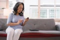 A senior woman's hand checking her blood sugar level with a glucometer by herself at her home. Royalty Free Stock Photo