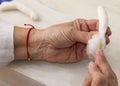 Senior woman`s hand filling with cotton piece to build rag doll Royalty Free Stock Photo