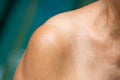 Senior woman`s shoulder, Close up, Blue swimming pool