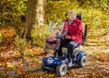 Senior woman with scooter in the park