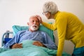 Senior woman with seriously ill husband in hospital. Healthcare support anxiety love concept Royalty Free Stock Photo