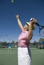 Senior Woman Serving Tennis Ball Royalty Free Stock Photo