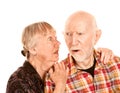 Senior woman sharing information with skeptical man Royalty Free Stock Photo