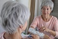 Senior woman shaving her hairy forearms