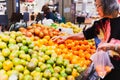 Senior woman shopping oranges at grocery store. Royalty Free Stock Photo