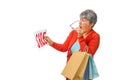 Senior woman shopping in surprise looks at the SALE on isolated Royalty Free Stock Photo