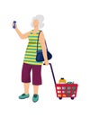 Senior woman shopping with a trolley full of groceries and checking a list. Elderly female with a shopping cart in