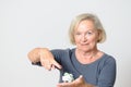 Senior Woman Showing Crumpled Money on Hand