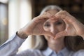 Senior woman showing finger heart shaped hands in focus