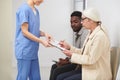 Senior Woman Signing Medical Document Royalty Free Stock Photo