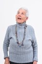 Senior woman singing on a white background