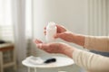 Senior woman sit on couch having daily vitamins or diet supplements at home, mature old female pensioner take dose of pills from Royalty Free Stock Photo