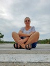 Senior Woman Sitting on a Crosswalk at Sanibel Florida Wildlife Refuge