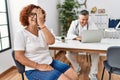 Senior woman sitting at doctor appointment covering one eye with hand, confident smile on face and surprise emotion Royalty Free Stock Photo