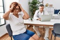 Senior woman sitting at doctor appointment suffering from headache desperate and stressed because pain and migraine Royalty Free Stock Photo