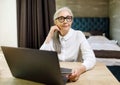 Senior Woman Sitting with Laptop