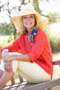 Senior Woman Sitting Outdoors On Bench Royalty Free Stock Photo