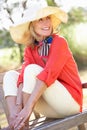 Senior Woman Sitting Outdoors On Bench Royalty Free Stock Photo