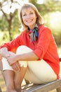 Senior Woman Sitting Outdoors On Bench Royalty Free Stock Photo